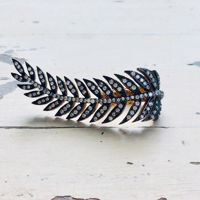 Vermeil leaf shape ring showcasing an antique finish and cubic zirconia embellishment, artistic gold statement jewelry.