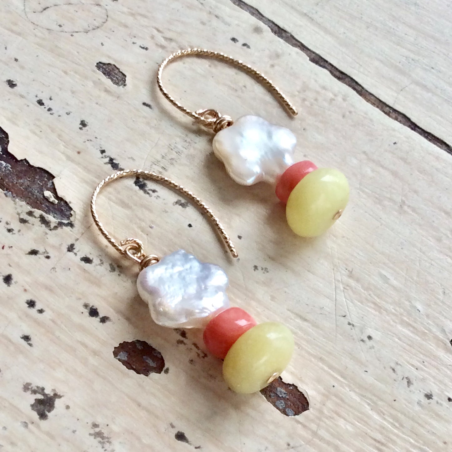 Dainty pearl drop earrings featuring baroque freshwater pearls, pink coral accents, and green quartz gemstones.