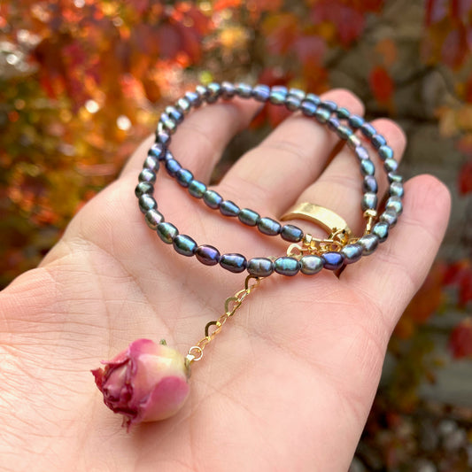 Pink Rosebud Pearl Necklace featuring black rice pearls and a preserved pink rosebud, handmade in Canada.