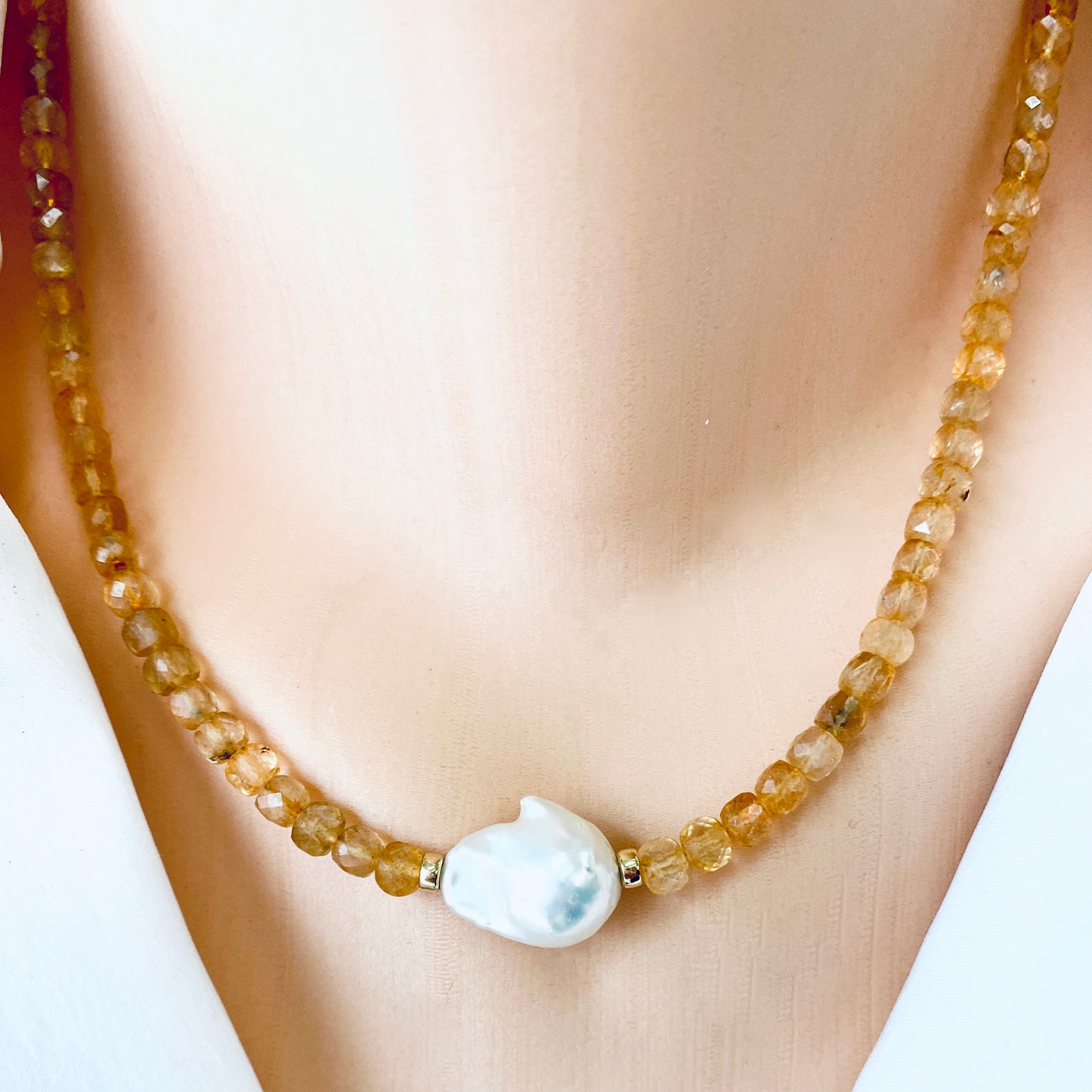 Citrine pearl choker necklace close up showing golden citrine beads and white baroque pearl centerpiece