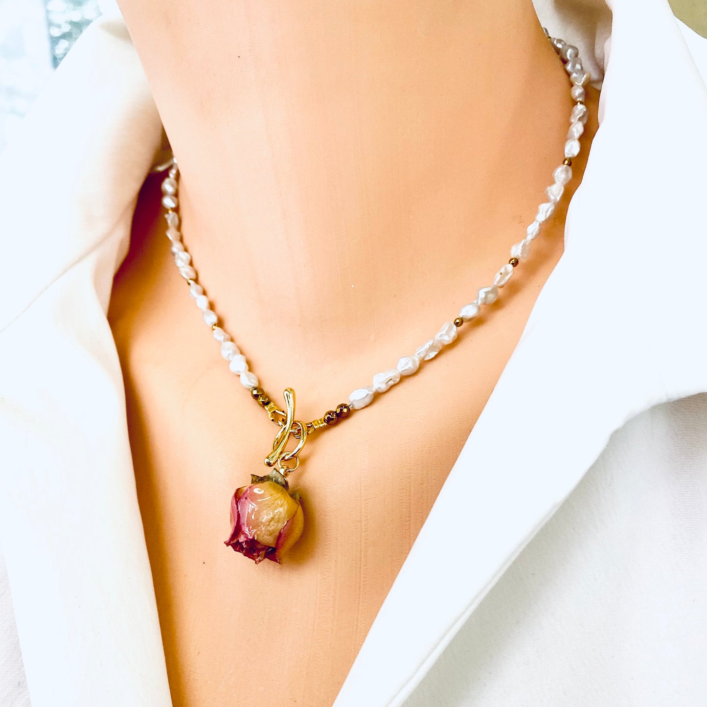 Real pink rosebud pearl necklace featuring preserved rosebud pendant and silver white pearls