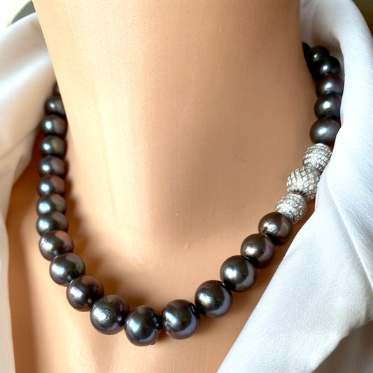Side view of black pearl silver necklace worn by mannequin in white blouse, 18-inch handmade jewelry piece