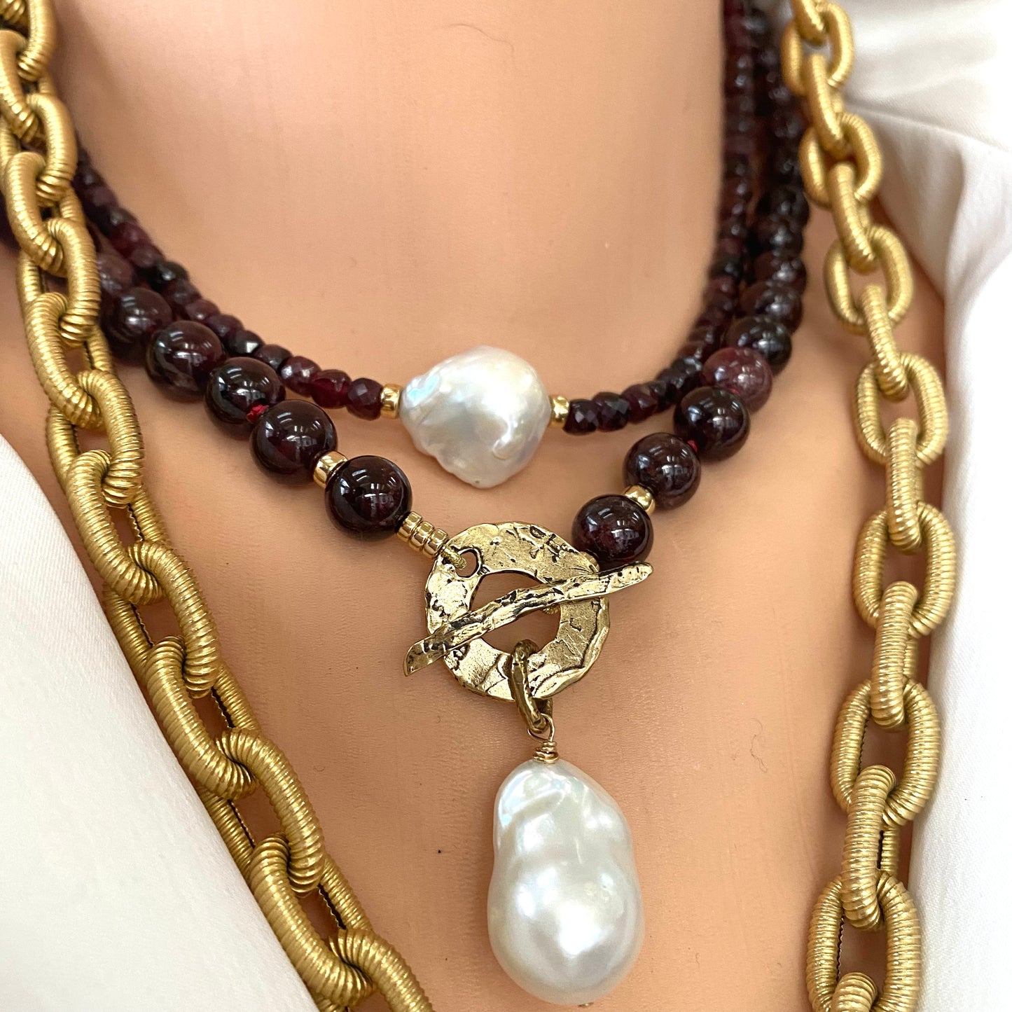 Garnet pearl necklace layered with gold chain and white baroque pearl accent