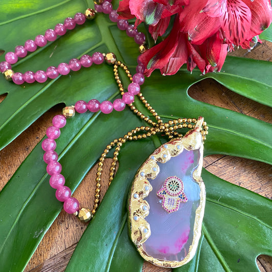 Hot Pink Agate Pendant Necklace – Chunky Silver Hamsa Statement with pink beads and lush greenery backdrop.
