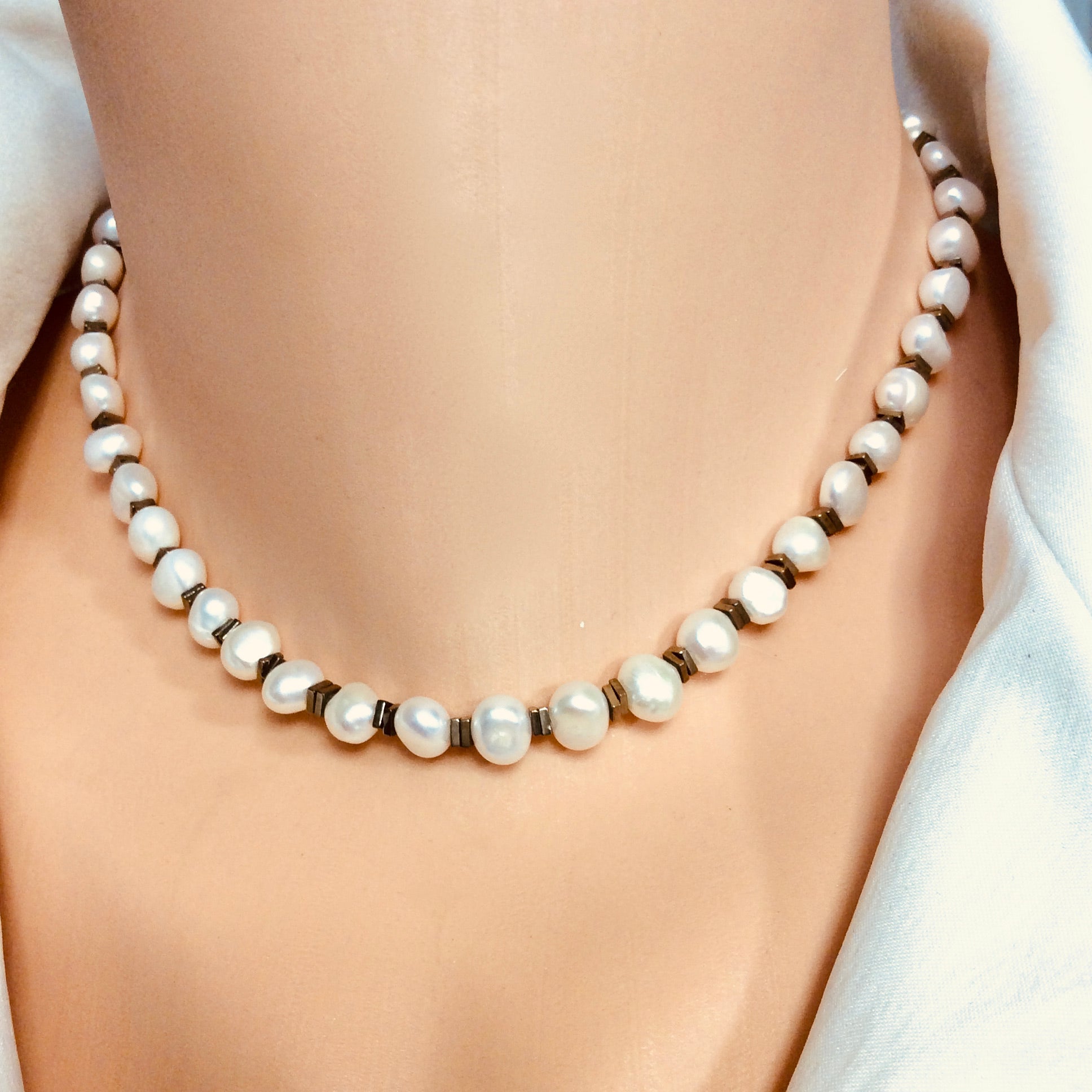 Pearl hematite choker necklace worn at collarbone with freshwater pearls