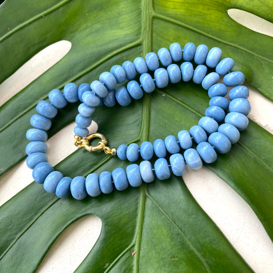Blue opal necklace styled on green leaves, hand-knotted Oregon blue opal candy strand