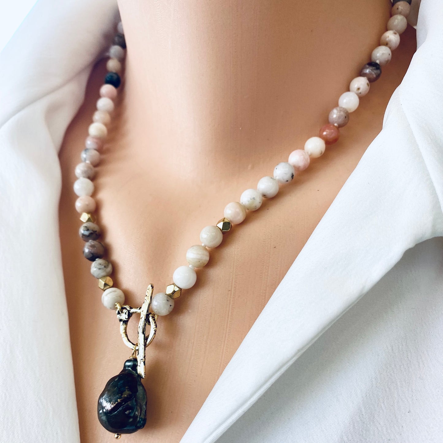 Pink opal baroque pearl necklace close up showing pink opal beads and black baroque pearl