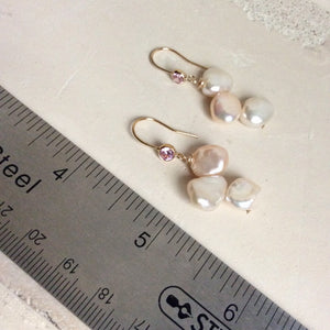 Elegant earrings composed of Natural Keshi pink and white pearls hanging from gold filled hooks with pink cubic zirconia bezel
