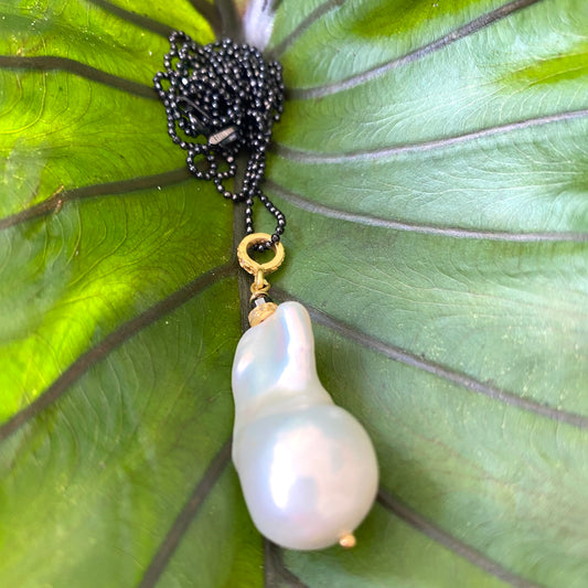 Baroque pearl diamond necklace featuring a lustrous freshwater baroque pearl and diamond pavé loop