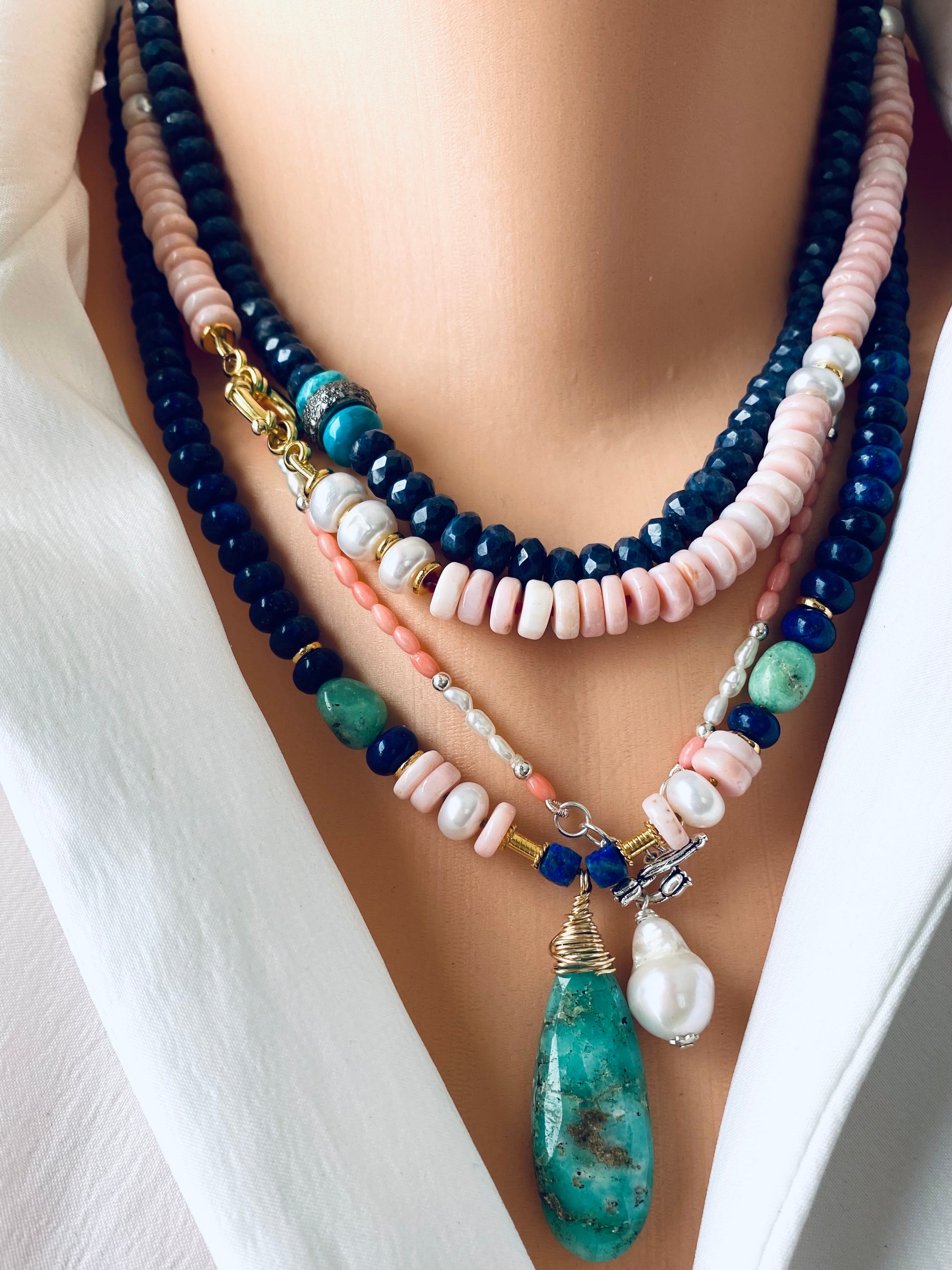 Pink opal pearl necklace layered with other necklaces featuring optional baroque pearl pendant