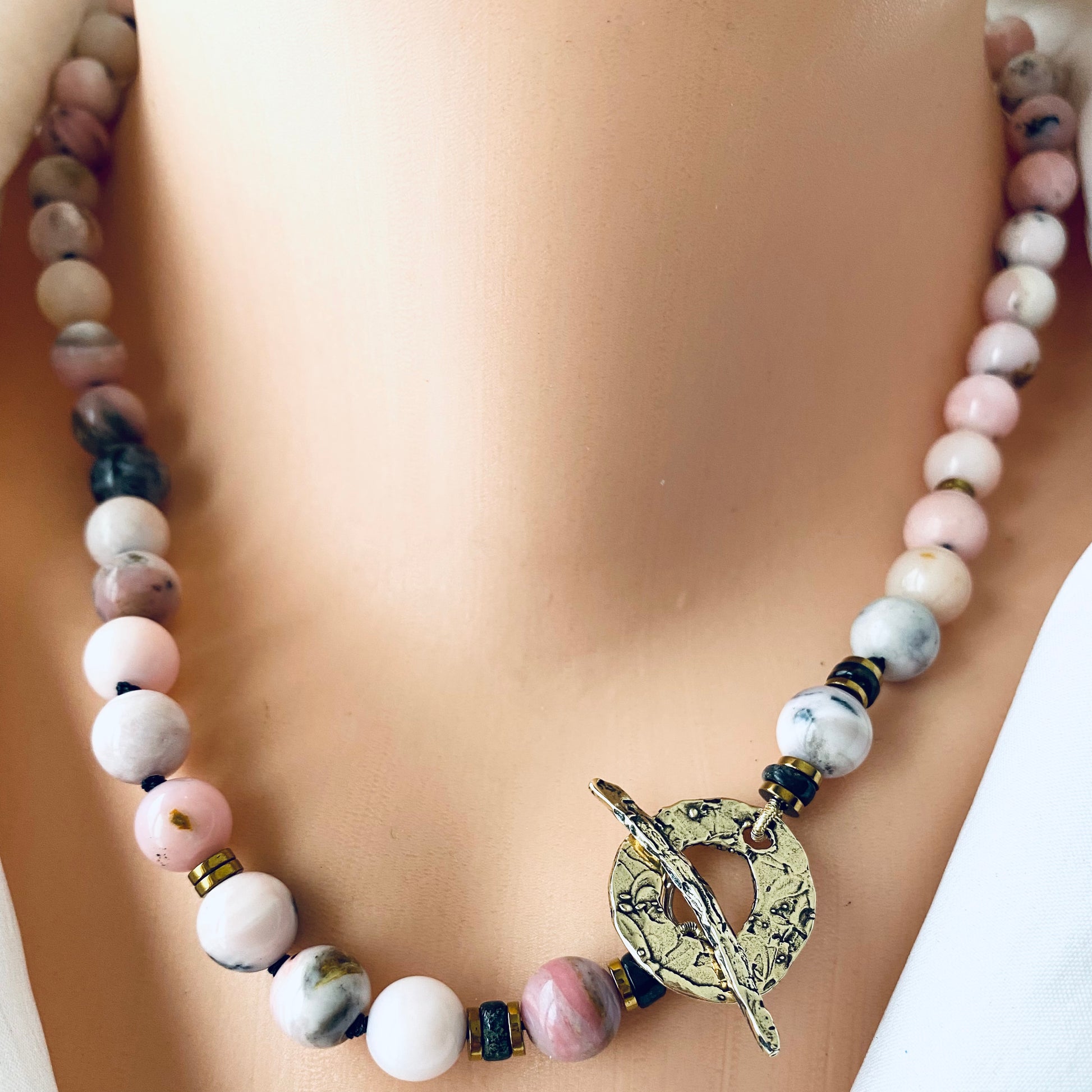 Pink opal hematite necklace with artisan gold bronze toggle clasp worn on model