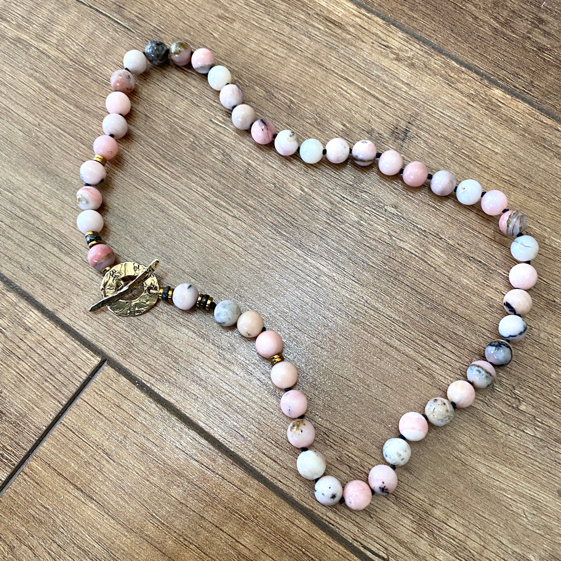 Pink opal hematite necklace with hand knotted pink opal beads and gold bronze toggle clasp