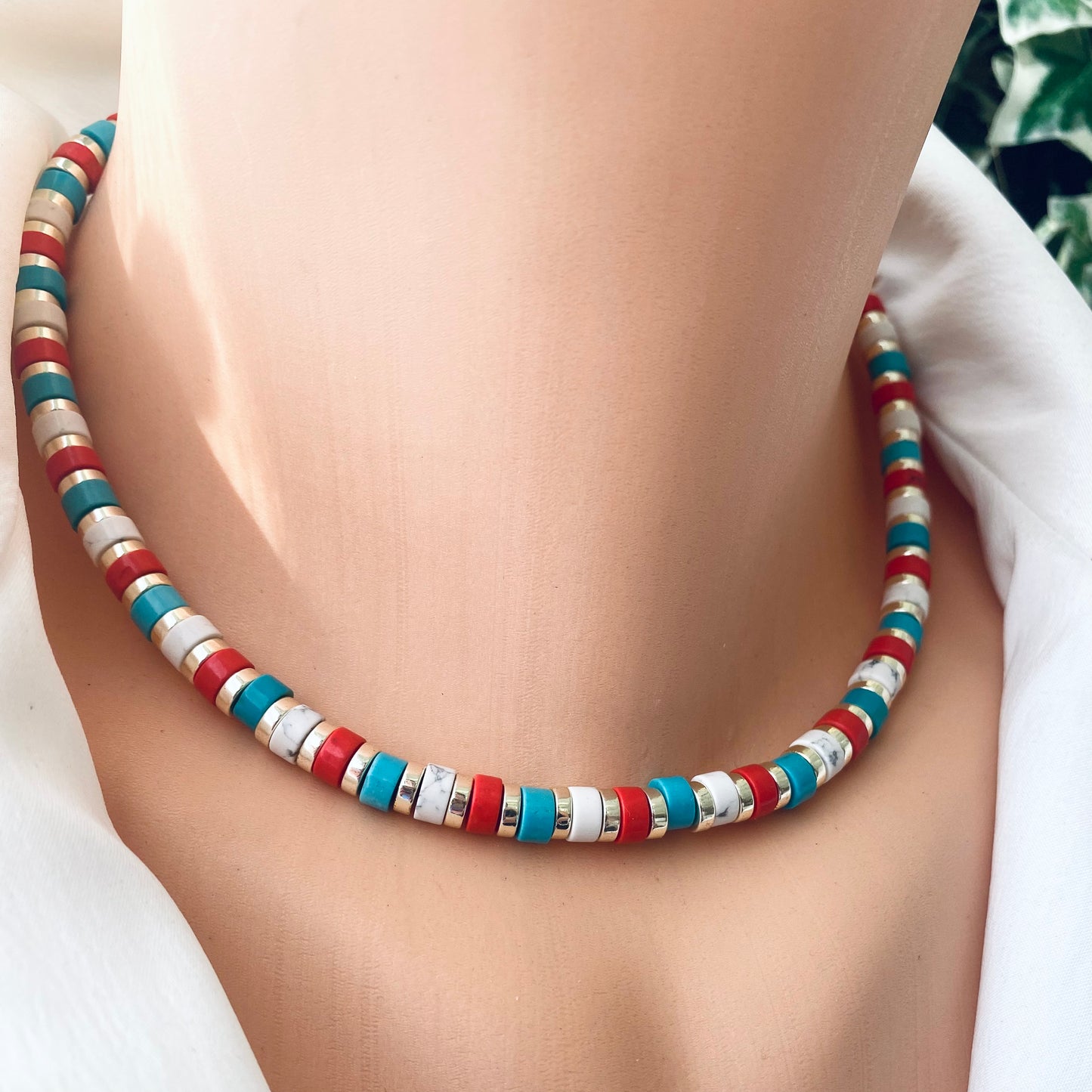 Gemstone choker necklace showcasing multi-color beads in red, turquoise, and white, perfect for colorful style.