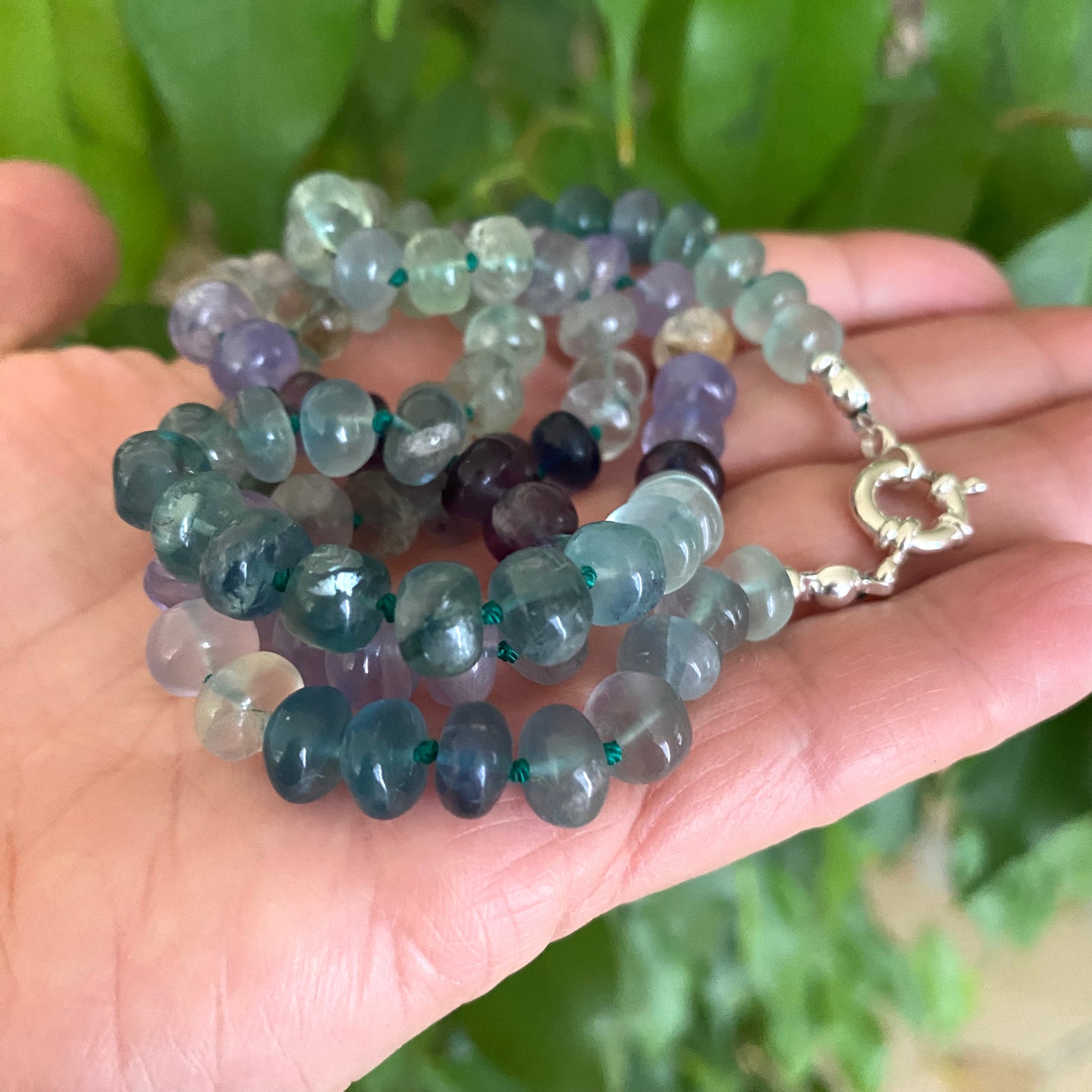 Fluorite candy necklace featuring multi-color fluorite rondelle beads in green, blue, purple, and golden tones.