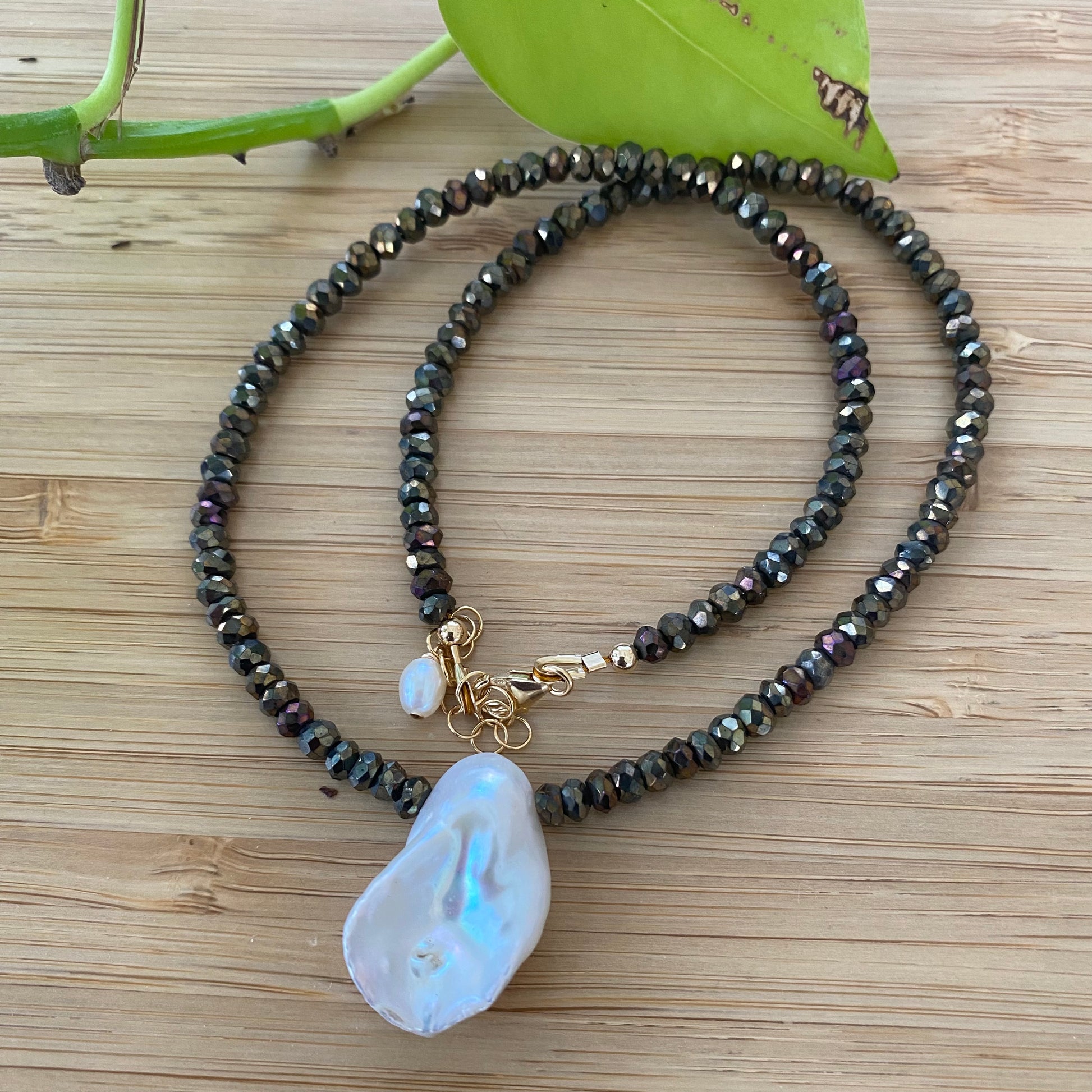 Pyrite pearl choker necklace with white keshi pearl, featuring faceted pyrite beads and a unique pearl centerpiece.