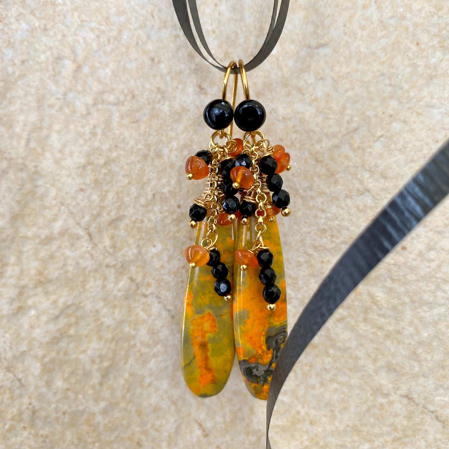 Bumble bee jasper earrings with carnelian and onyx clusters, showcasing vibrant yellow, orange, and black hues, handcrafted design.