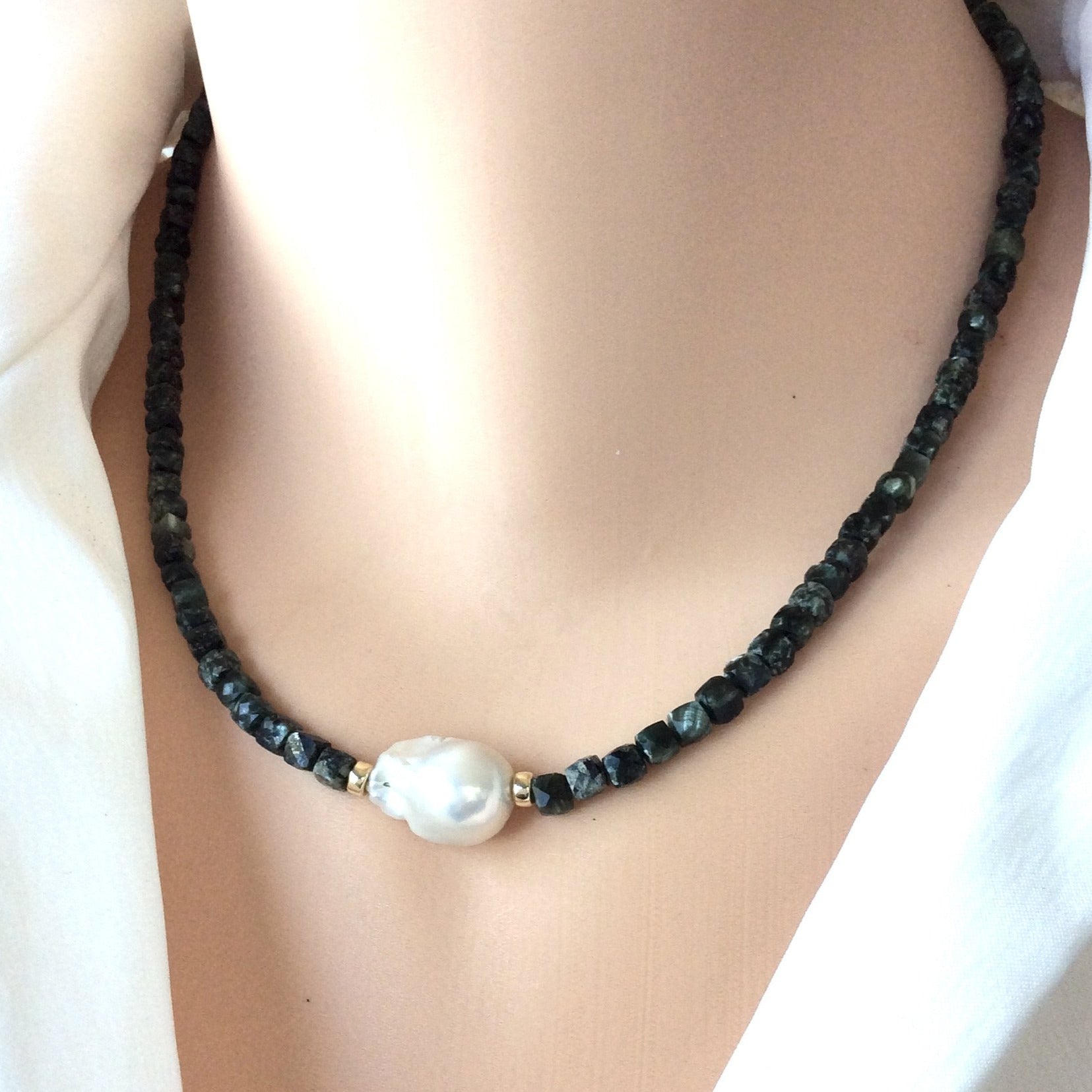Seraphinite pearl choker necklace worn at the neckline with deep green seraphinite beads and white baroque pearl