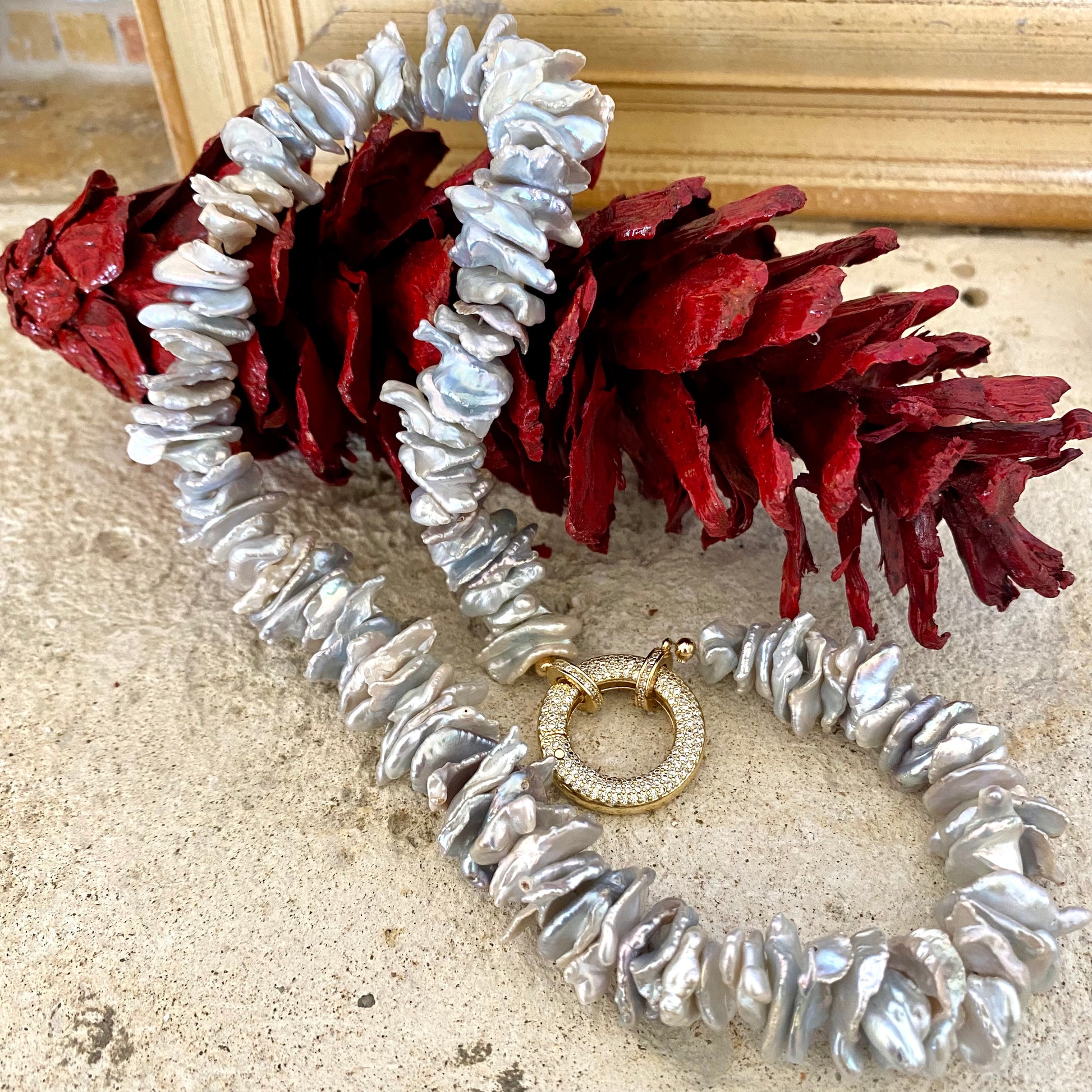 Keshi pearl choker necklace featuring chunky grey keshi pearls and a unique round clasp, showcasing organic elegance.