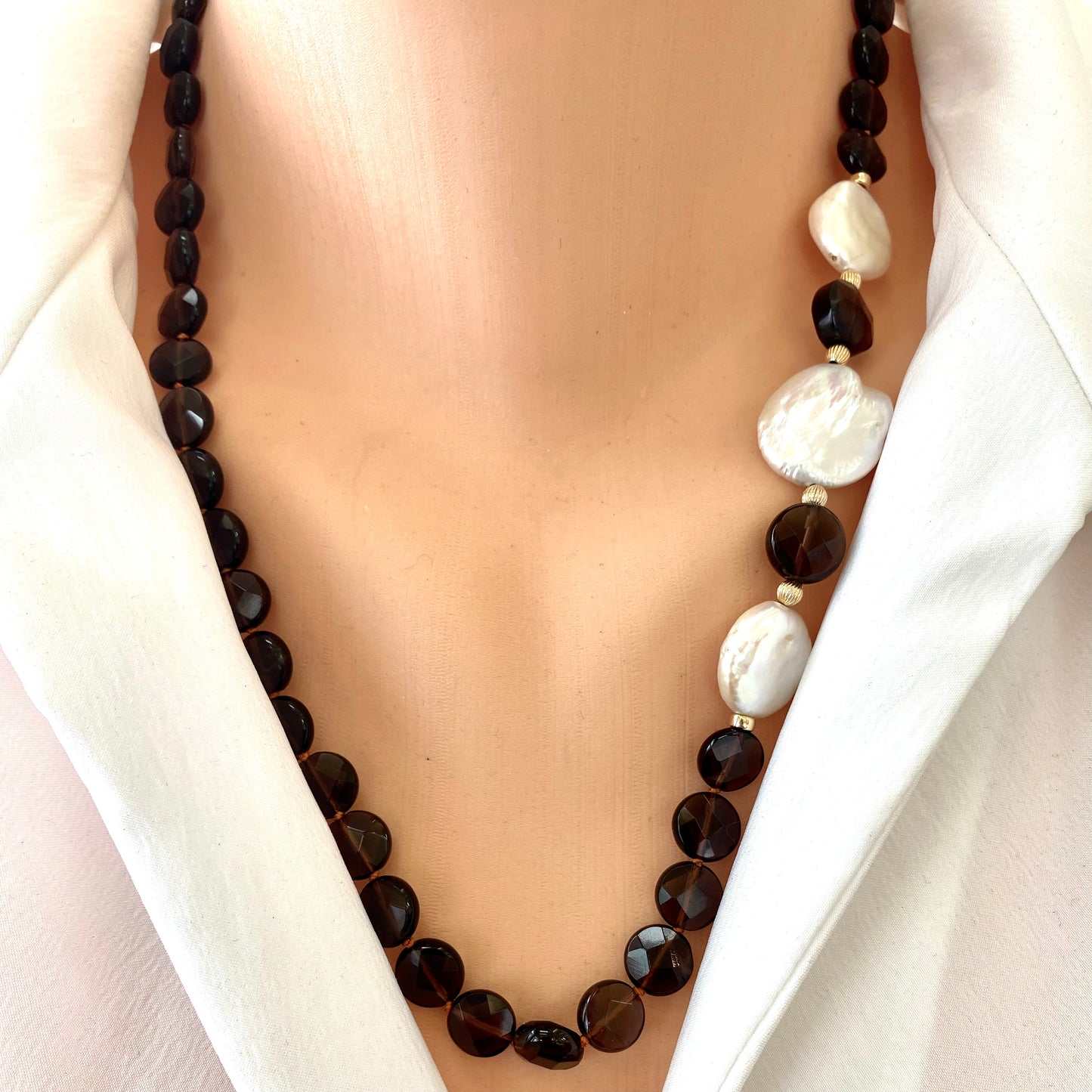 Smoky quartz pearl necklace with coin pearls showcasing elegance and earthy tones on a model's neck.