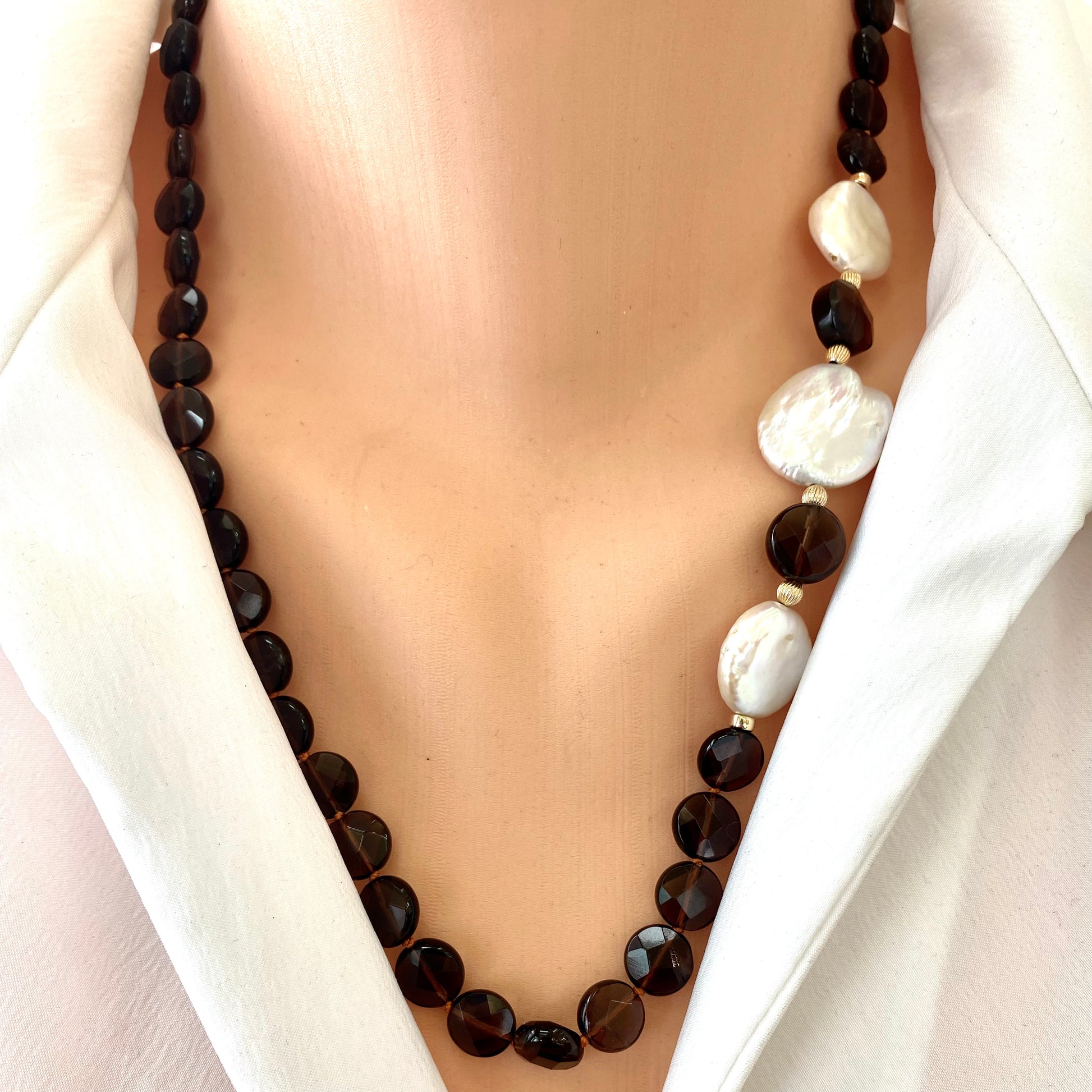 Smoky quartz pearl necklace with coin pearls showcasing elegance and earthy tones on a model's neck.