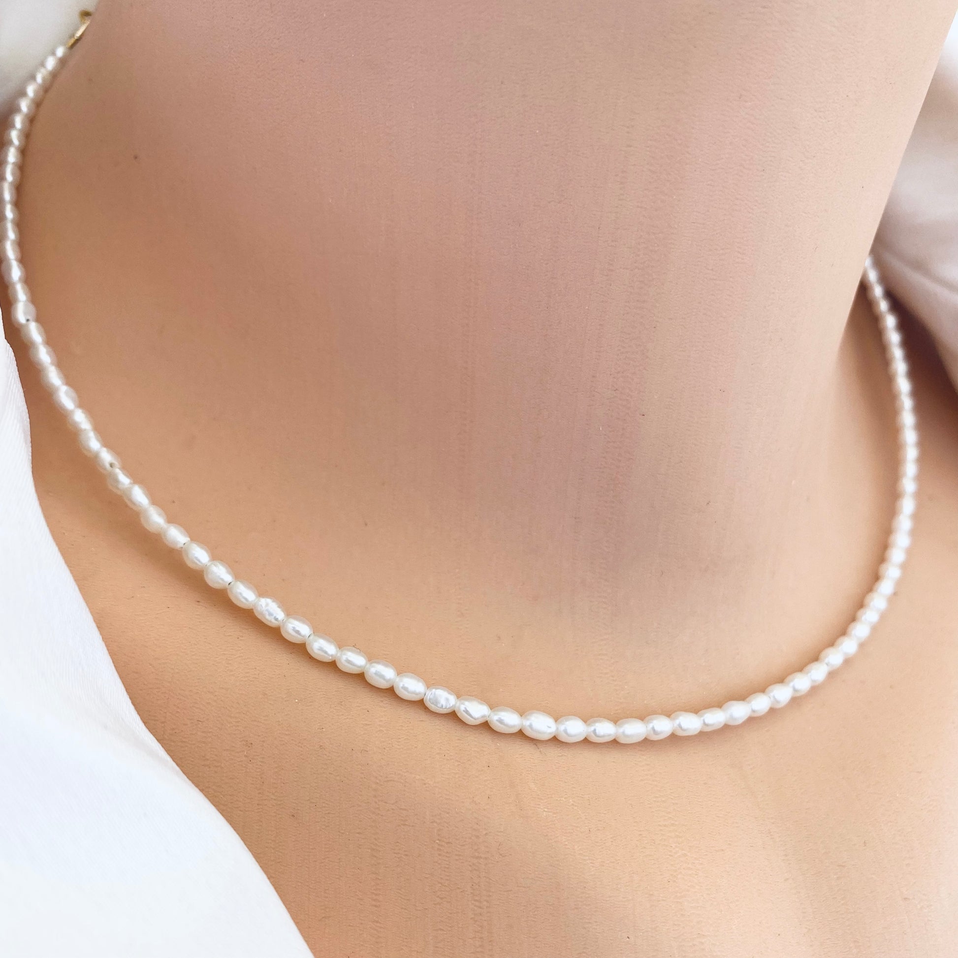 Elegant pearl necklace showcasing mini rice freshwater pearls, perfect for summer fashion.