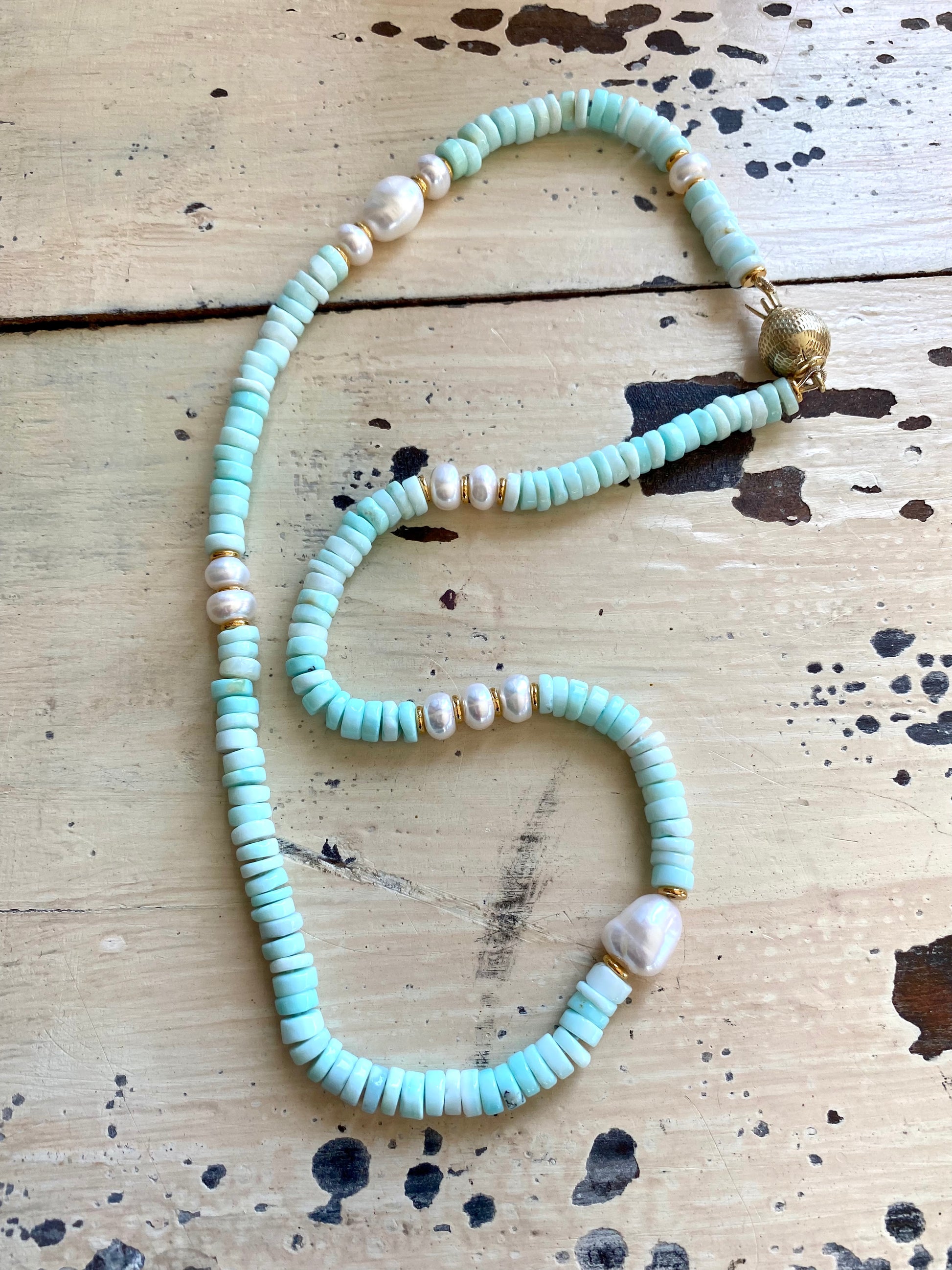 Sky blue opal pearl necklace arranged flat to show full length and bead details, handmade in Canada