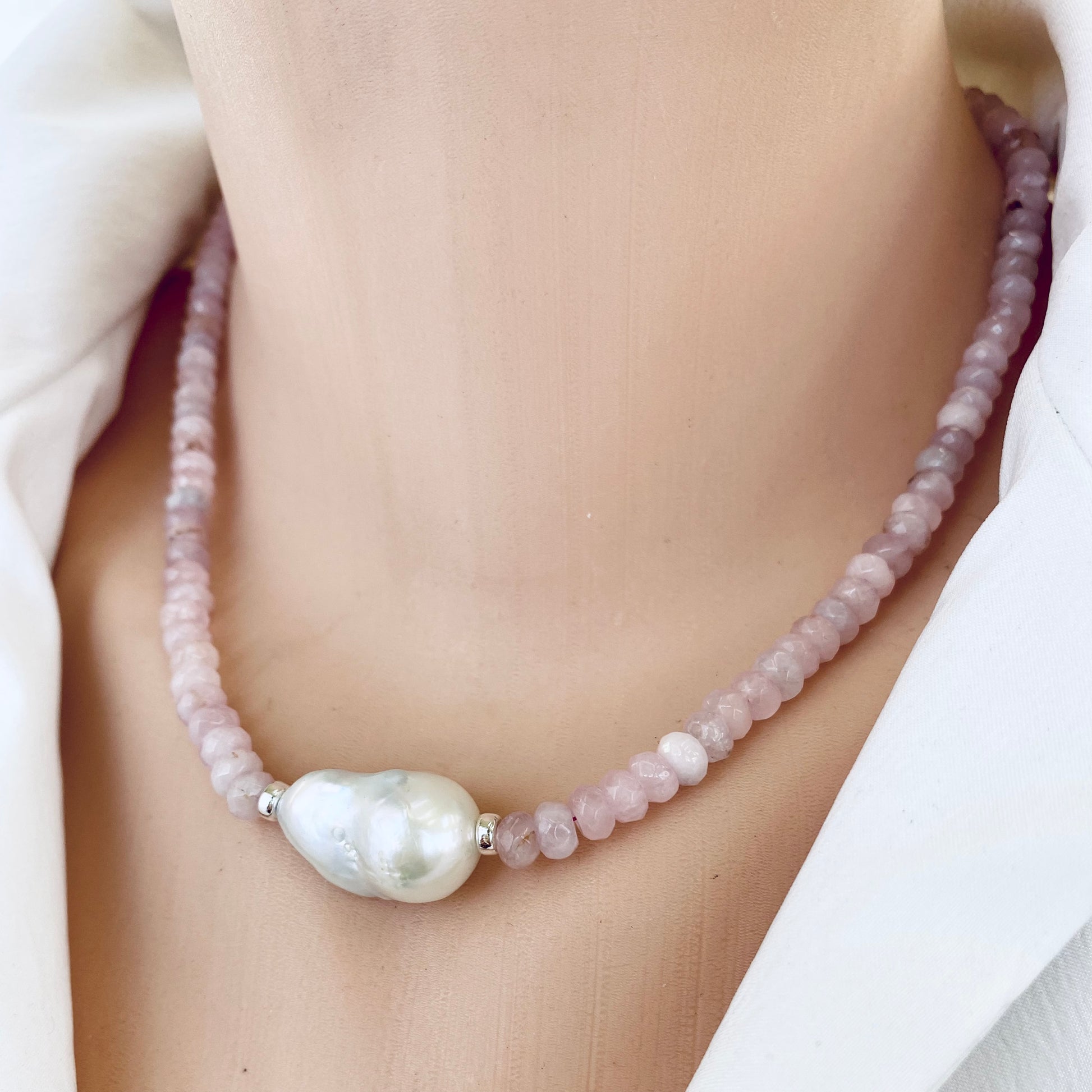 Rose quartz pearl necklace close-up on neck with central baroque pearl, handmade in Canada