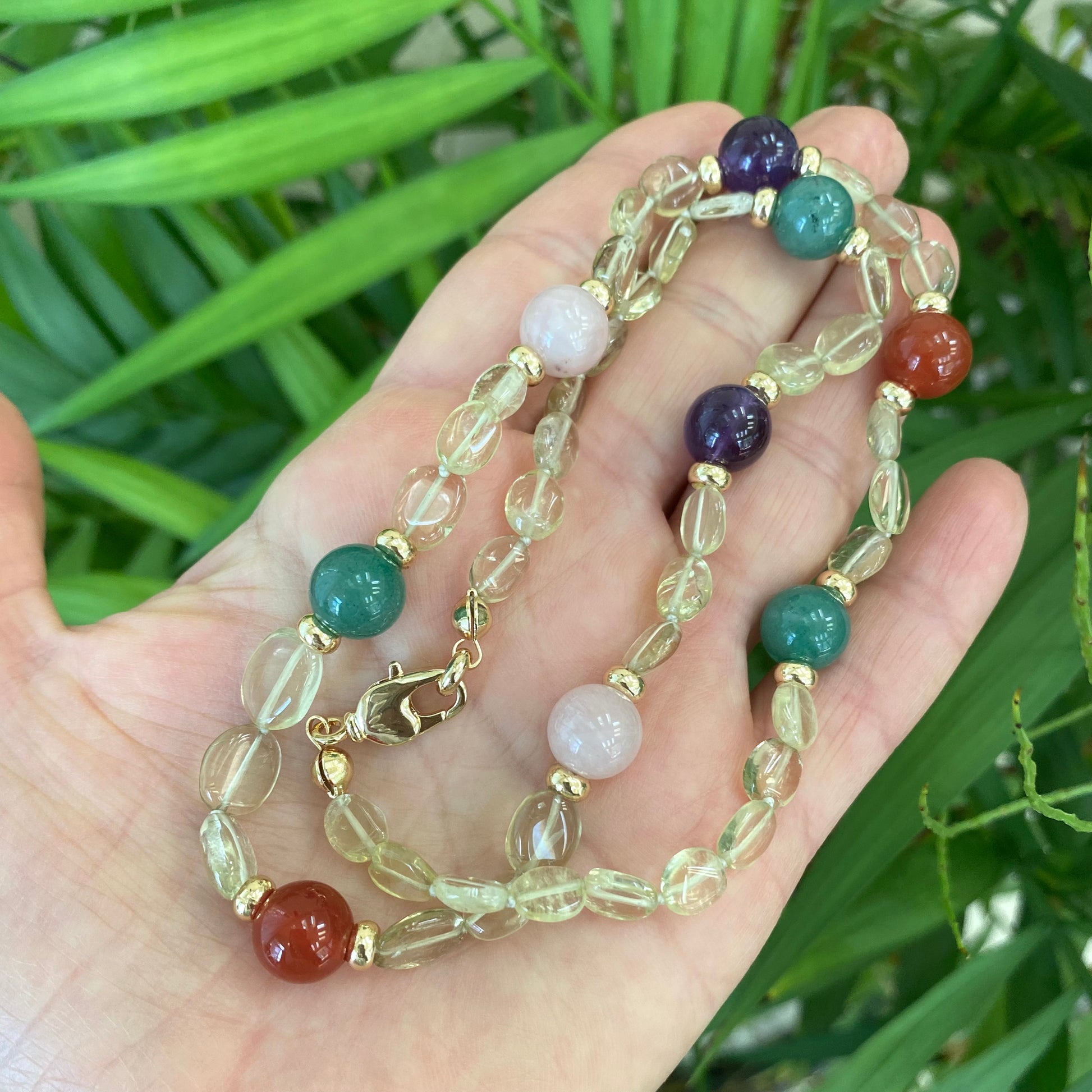 Prasiolite bonbons necklace with mixed gemstone beads held in hand, handmade Canadian jewelry