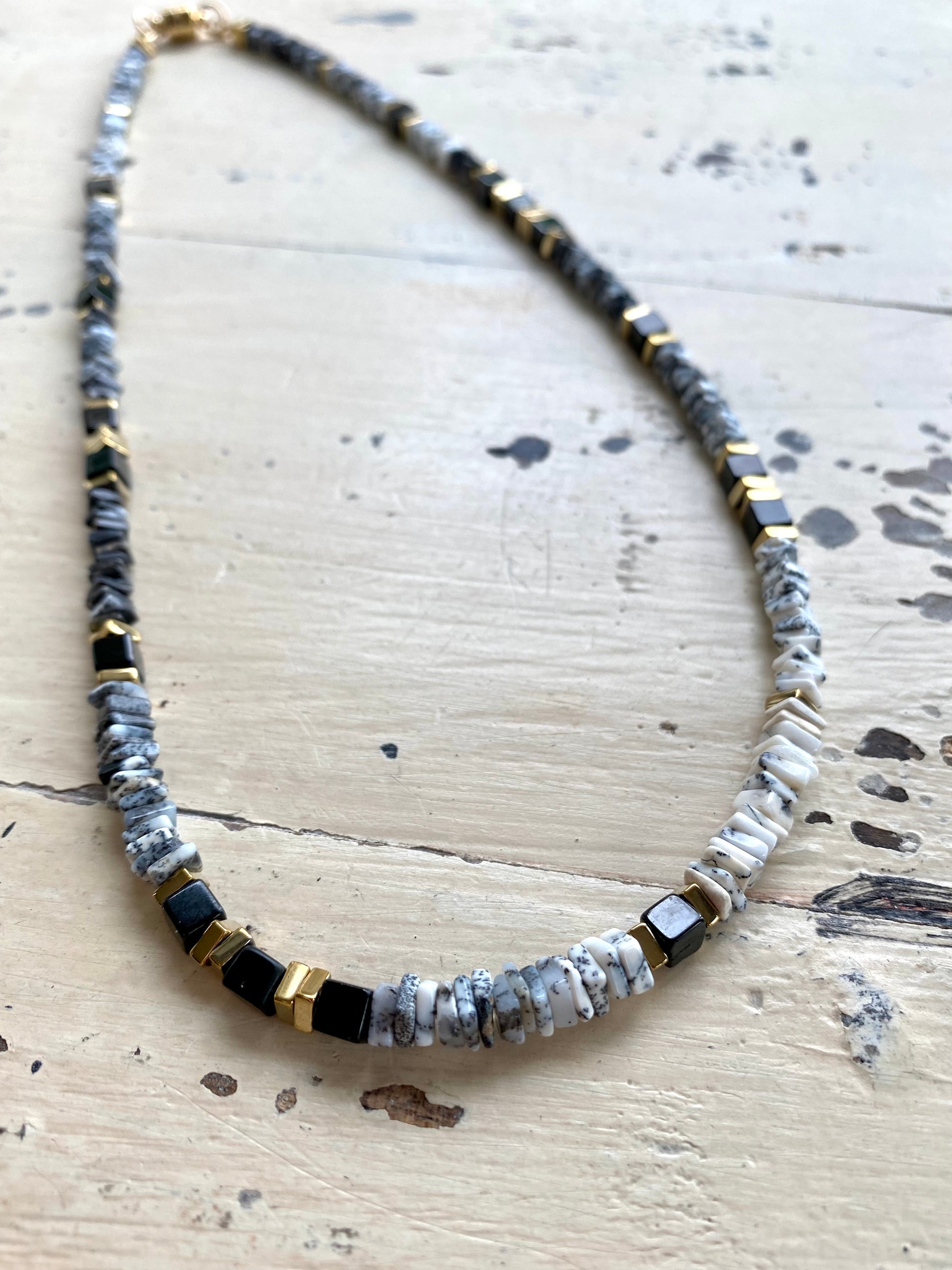 Dendritic opal necklace worn at neckline, clean modern gemstone necklace styling