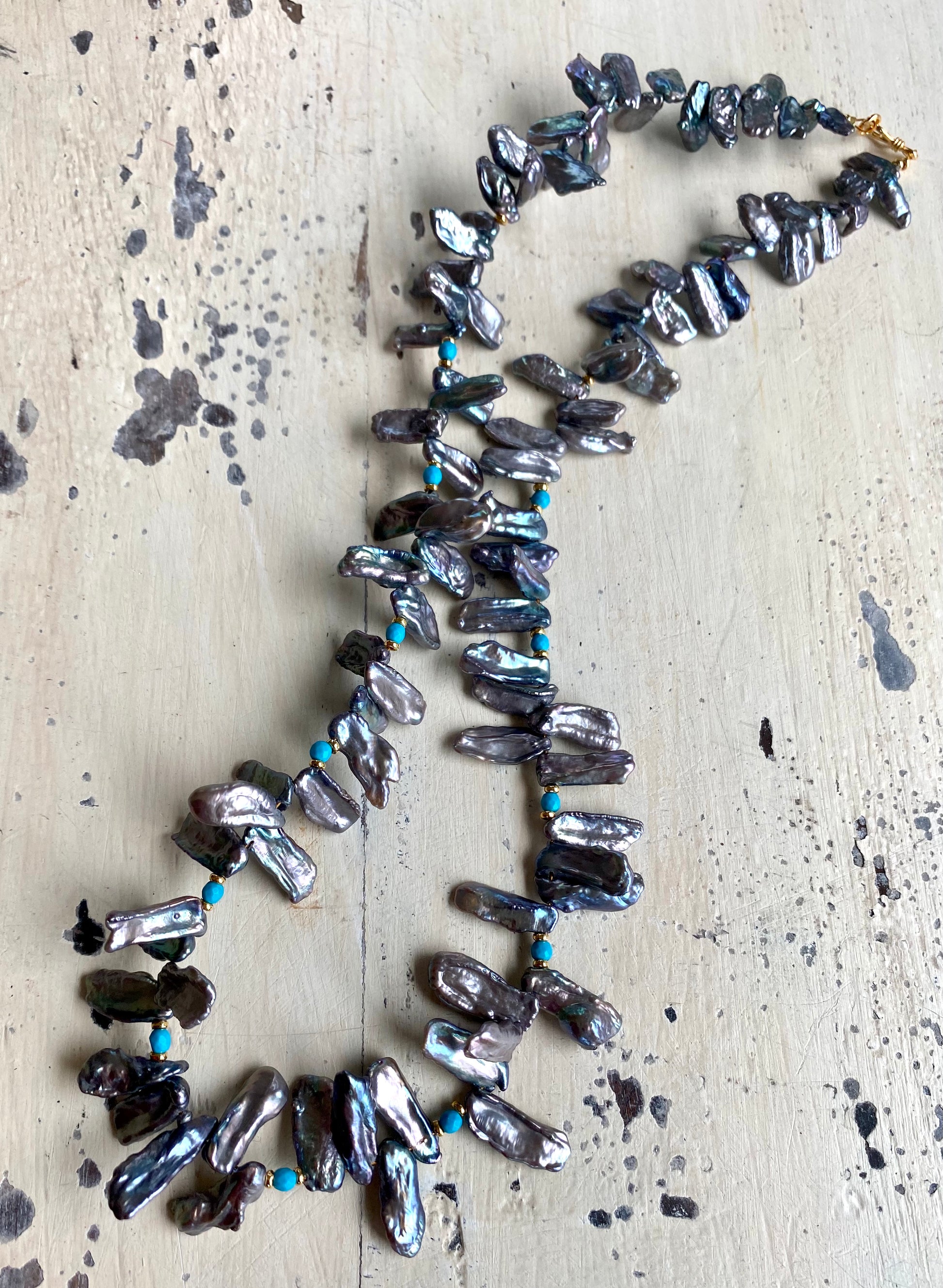 Biwa pearl turquoise necklace flat lay, keshi stick pearls with faceted turquoise and vermeil accents