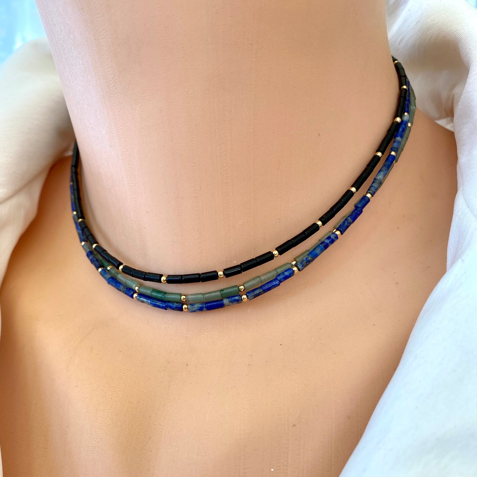 Lapis lazuli onyx choker necklace worn on model featuring blue lapis tube beads