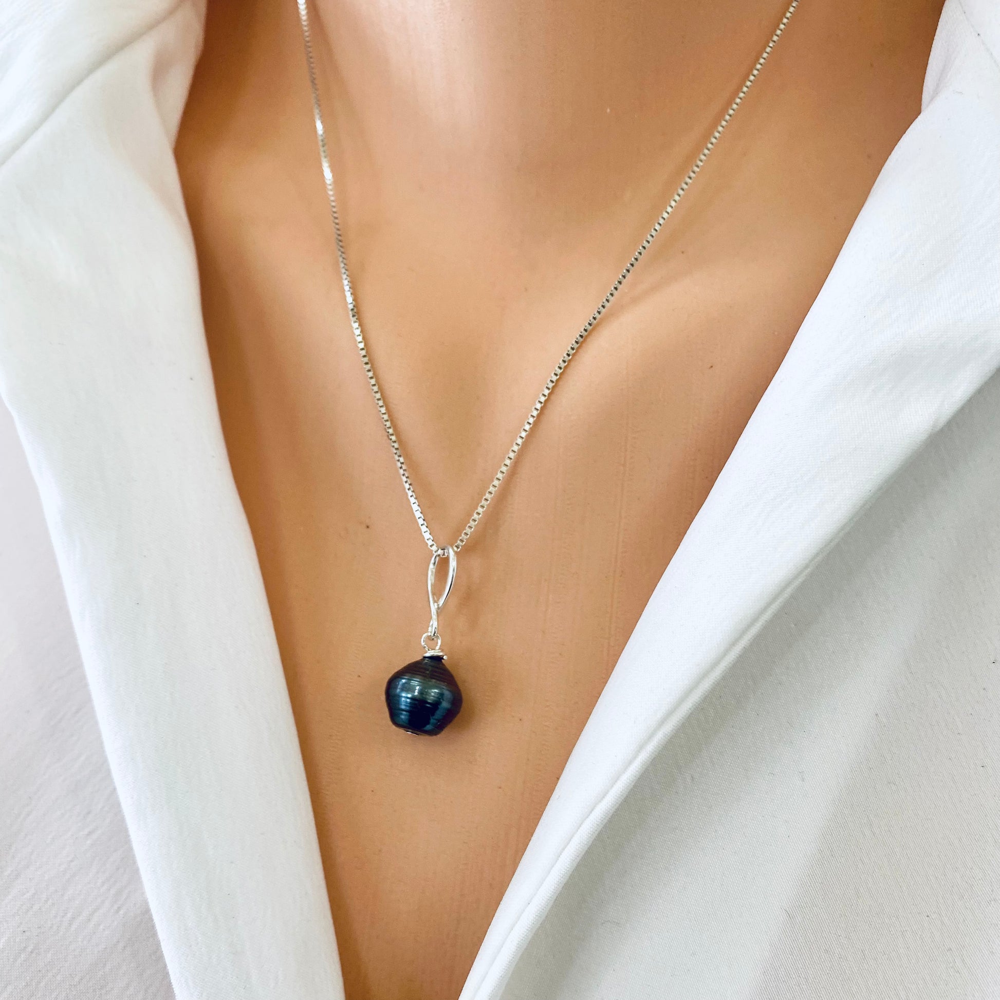 Tahitian teardrop pearl pendant box chain worn close-up, teardrop baroque Tahitian pearl pendant