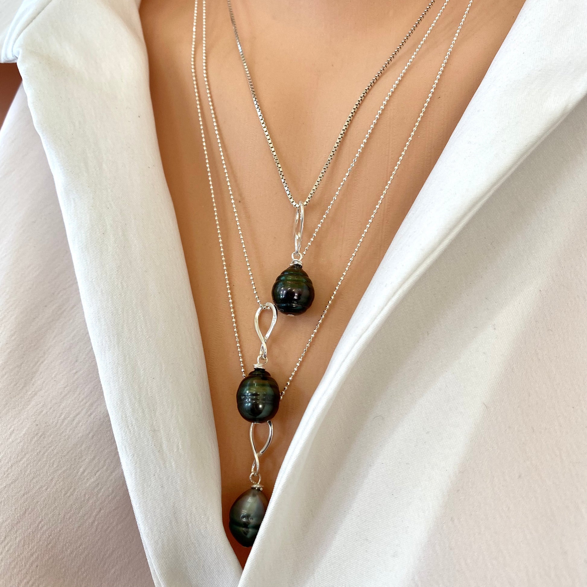 Tahitian teardrop pearl pendant necklace layered on model, dark Tahitian pearl pendant on sterling silver chain