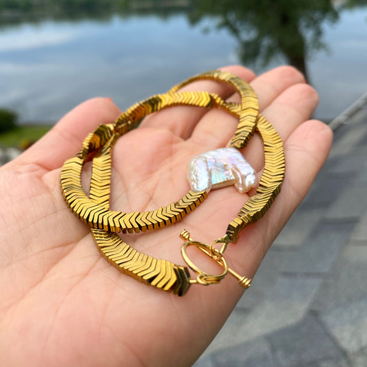 Gold hematite keshi pearl necklace close-up worn on model with square pearl centerpiece