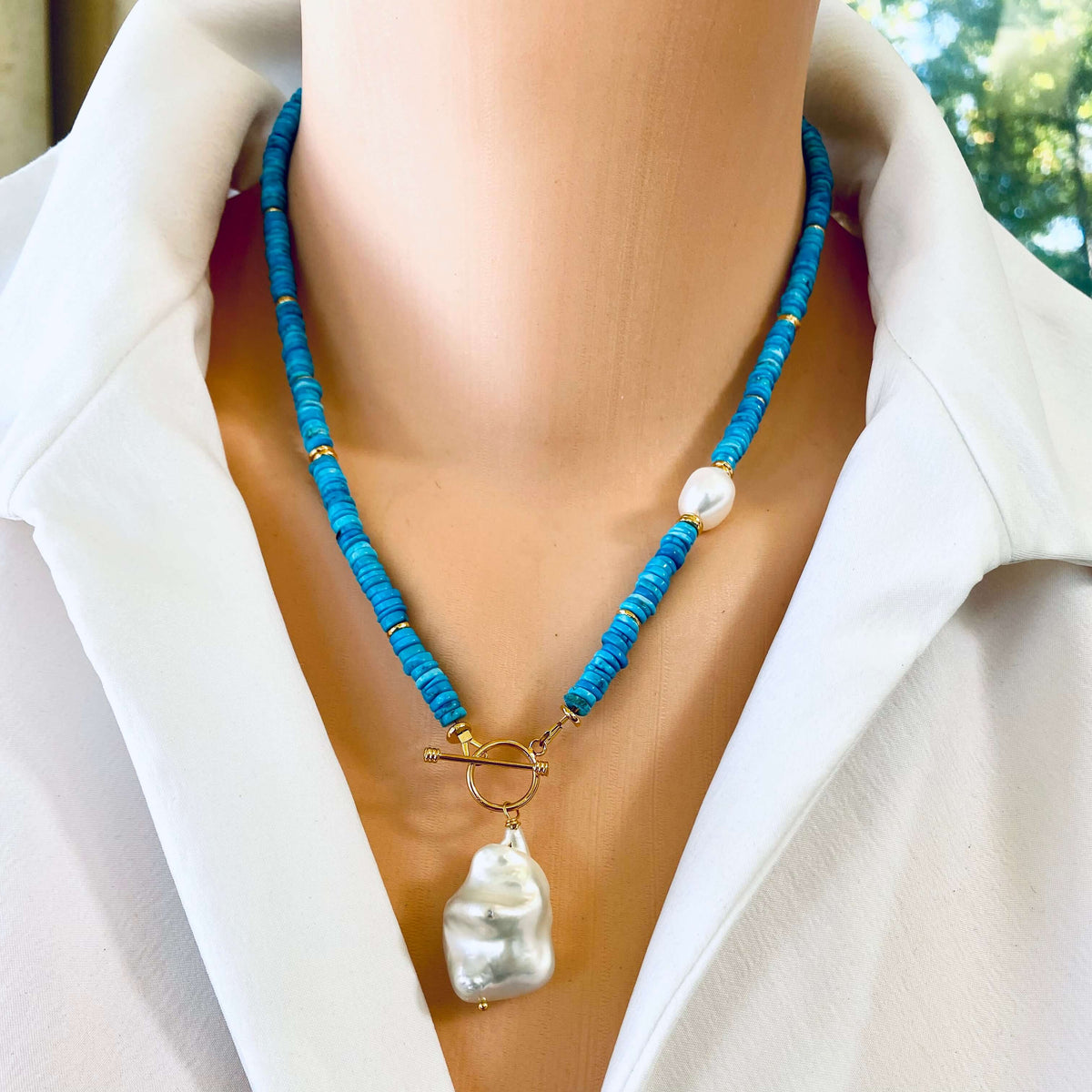 Turquoise Pearl Toggle Necklace featuring turquoise tire beads and baroque pearl pendant on a mannequin.