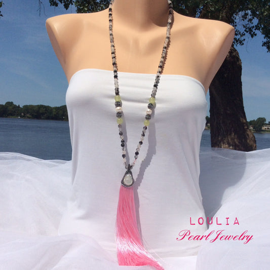 Model wearing rutilated quartz necklace by a sunny river backdrop, boho gemstone jewelry.