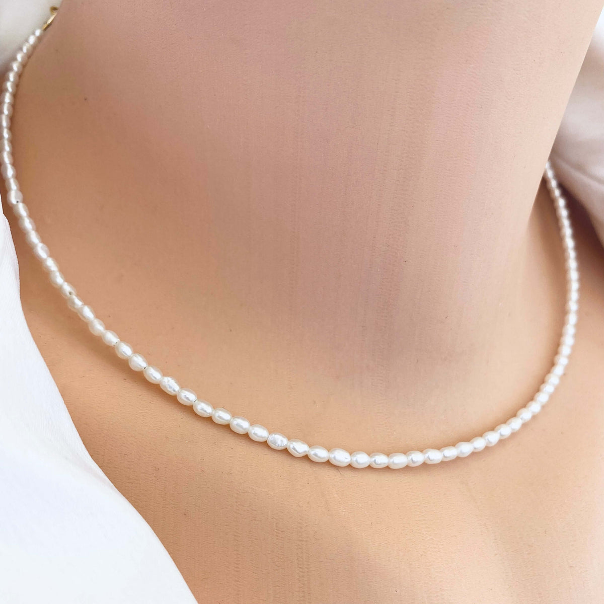 Elegant pearl necklace showcasing mini rice freshwater pearls, perfect for summer fashion.